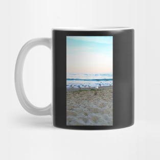 Seagulls sit on the beach Mug